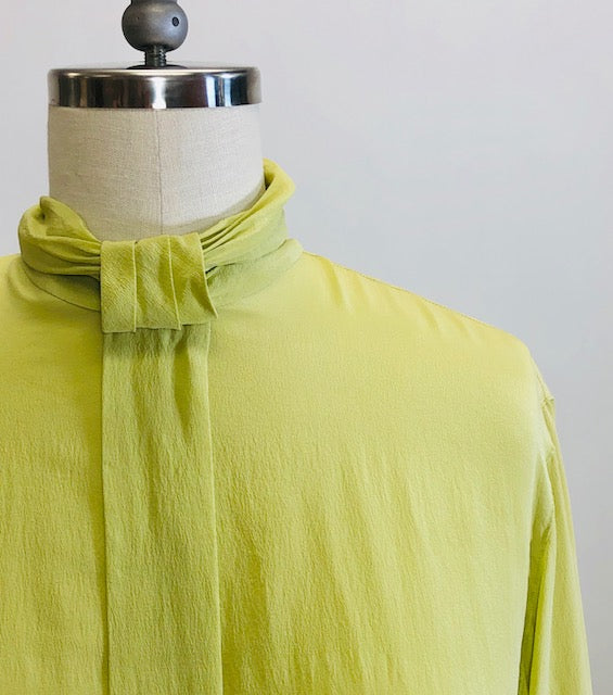 Exquisite lime silk blouse with lightly gathered neck band collar detail, button-down back, and long sleeves with buttoned cuffs. Looks beautiful paired with casual bottoms or as a dressy look.