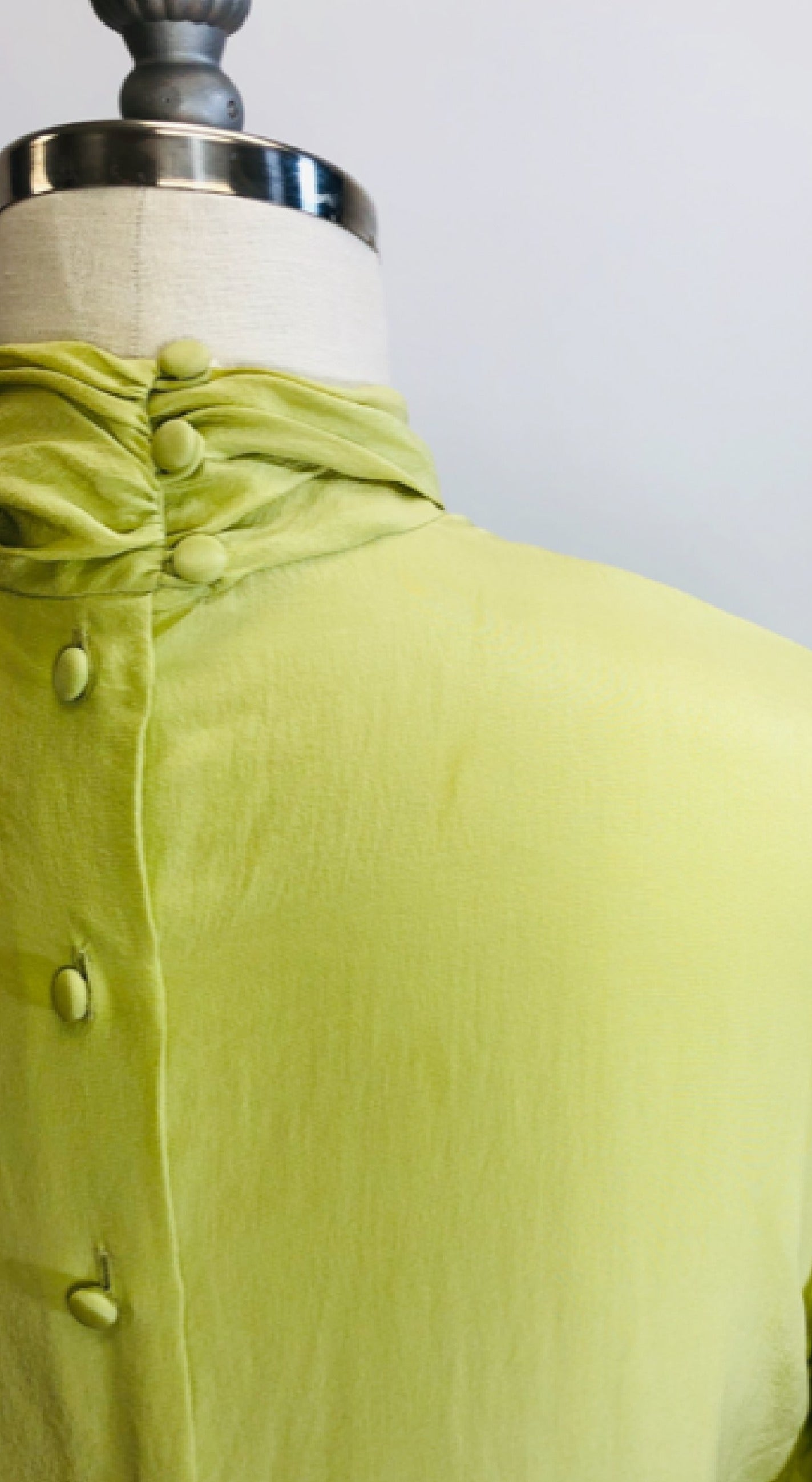 Exquisite lime silk blouse with lightly gathered neck band collar detail, button-down back, and long sleeves with buttoned cuffs. Looks beautiful paired with casual bottoms or as a dressy look.