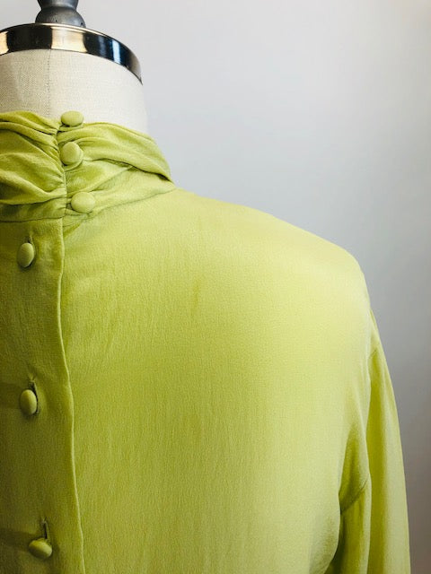 Exquisite lime silk blouse with lightly gathered neck band collar detail, button-down back, and long sleeves with buttoned cuffs. Looks beautiful paired with casual bottoms or as a dressy look.