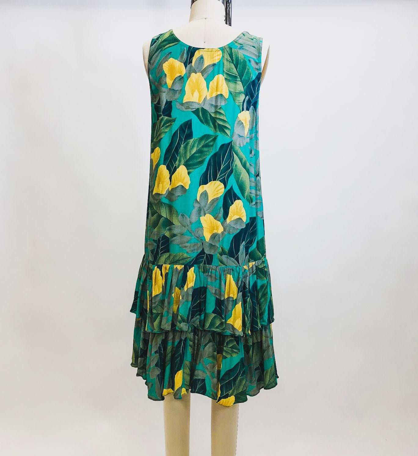 Beautiful vintage Alfred Sung rayon sleeveless dress with 20s inspired low waist ruffle hem and straight silhouette. This dress has a gorgeous tropical print of green and yellow florals. Label Sung Sport by Alfred Sung.