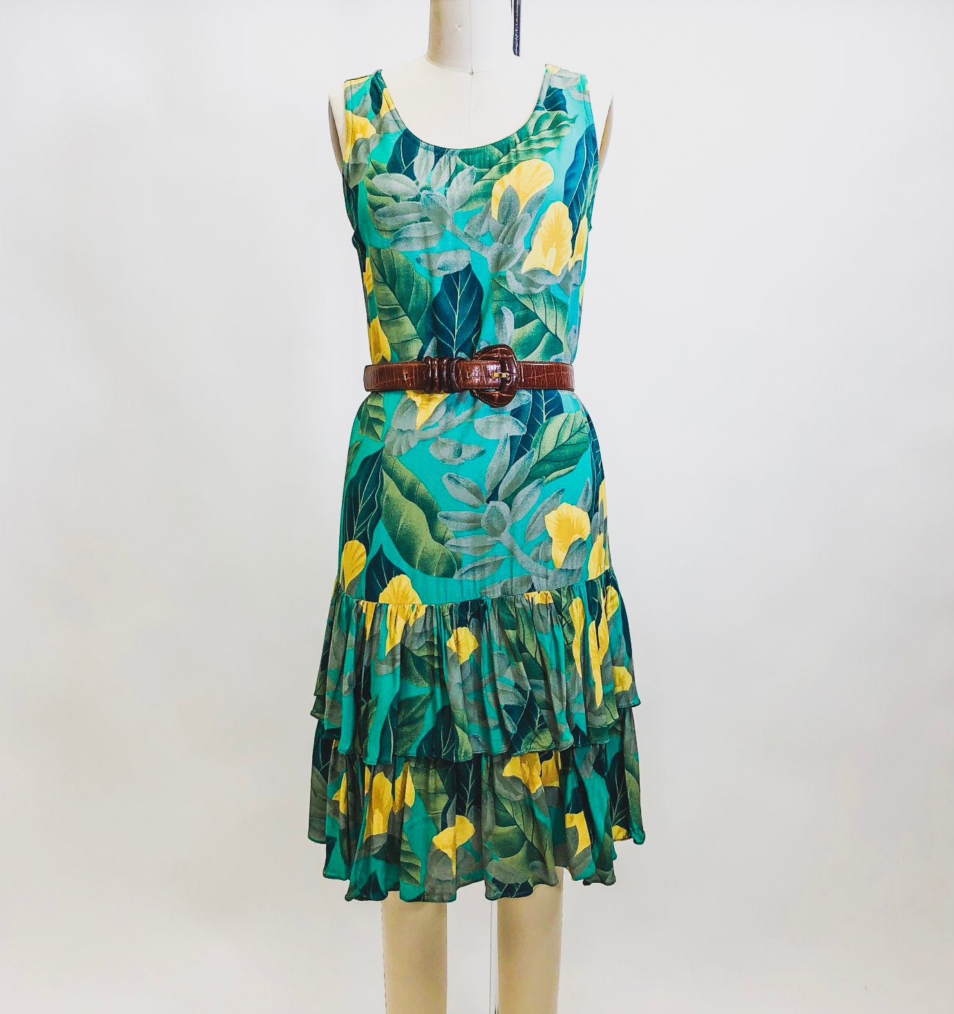 Beautiful vintage Alfred Sung rayon sleeveless dress with 20s inspired low waist ruffle hem and straight silhouette. This dress has a gorgeous tropical print of green and yellow florals. Label Sung Sport by Alfred Sung.