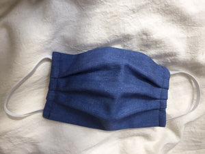 This is a double-layer face mask made of unused deadstock / remnant fabric in a vintage denim. A pleated style that is washable and reusable. Denim cotton-blend. Made in Canada.