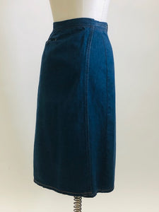 Adorable A-line denim skirt that falls below knee with unique wrap on the back with attached denim belt, and cute welt pocket on back. Such a sweet skirt for the vintage girl.  