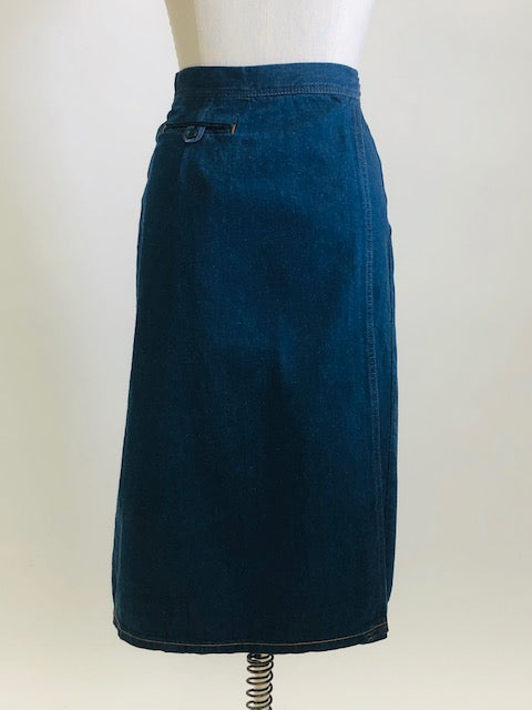 Adorable A-line denim skirt that falls below knee with unique wrap on the back with attached denim belt, and cute welt pocket on back. Such a sweet skirt for the vintage girl.  