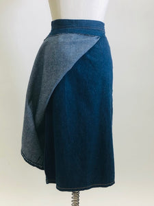 Adorable A-line denim skirt that falls below knee with unique wrap on the back with attached denim belt, and cute welt pocket on back. Such a sweet skirt for the vintage girl.  