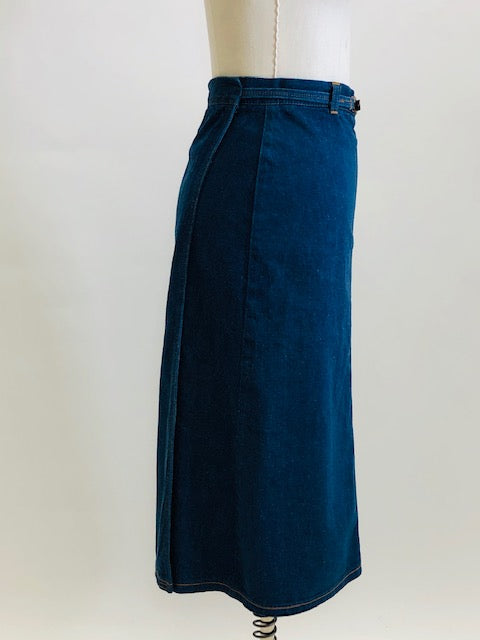 Adorable A-line denim skirt that falls below knee with unique wrap on the back with attached denim belt, and cute welt pocket on back. Such a sweet skirt for the vintage girl.  