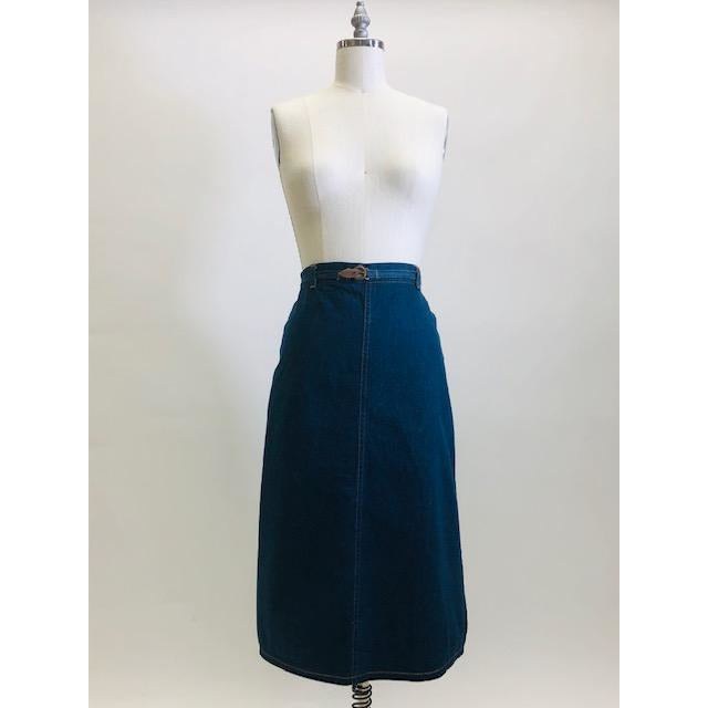 Adorable A-line denim skirt that falls below knee with unique wrap on the back with attached denim belt, and cute welt pocket on back. Such a sweet skirt for the vintage girl.  