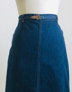 Adorable A-line denim skirt that falls below knee with unique wrap on the back with attached denim belt, and cute welt pocket on back. Such a sweet skirt for the vintage girl.  