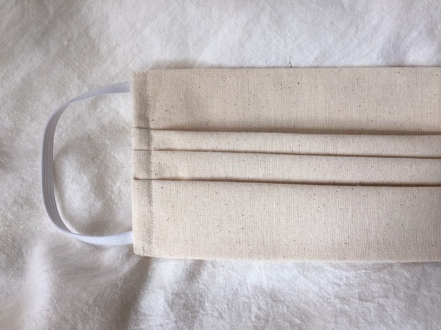 This is a triple-layer eco-friendly face mask made of 100% unbleached organic muslin cotton with elastic loops. Great alternative for those of us with skin sensitivities to bleaches and dyes. A pleated style that is washable and reusable. Made in Canada. 