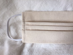 This is a triple-layer eco-friendly face mask made of 100% unbleached organic muslin cotton with elastic loops. Great alternative for those of us with skin sensitivities to bleaches and dyes. A pleated style that is washable and reusable. Made in Canada. 