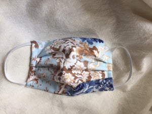 This is a double-layer face mask made of unused deadstock / remnant fabric in a beautiful vintage romantic floral print. A pleated style that is washable and reusable. Fit is for Adult, with ¼” flat braided elastic to securely hold behind ears. Made in Canada. 