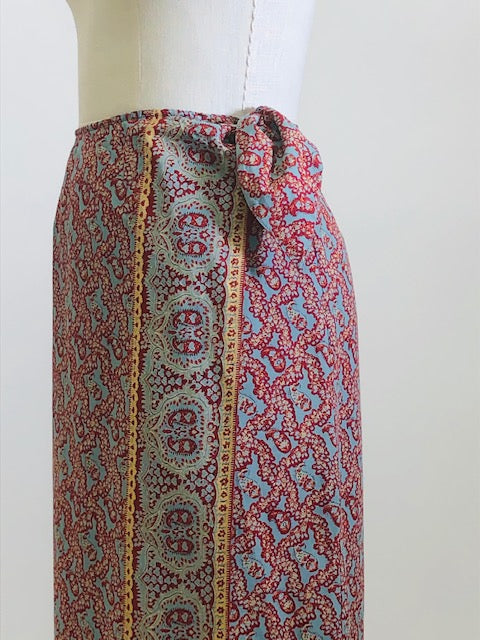 Vintage Ralph Lauren wrap midi cotton skirt with side waist tie in a vibrant paisley print of blues, reds and light orange, accented by a striking border. 