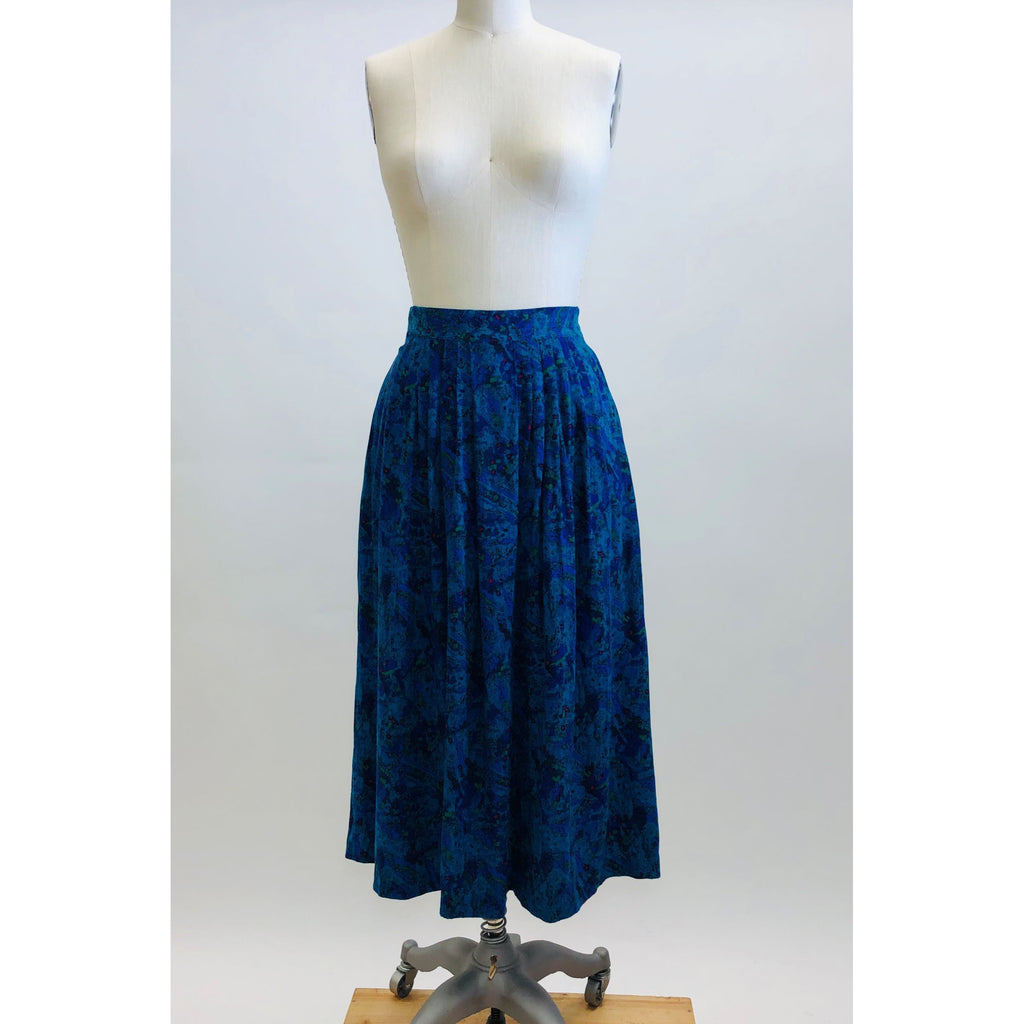 Lovely vintage 80s rayon midi pleated skirt with swirls of turquoise, green, blue and pink accents. This skirt features elasticated back waistband, and inseam side pockets. Made in Canada. 